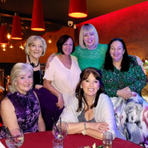 Women enjoying a Chinese banquet in Ormskirk, sharing food, laughter, and conversation at a local social dining event
